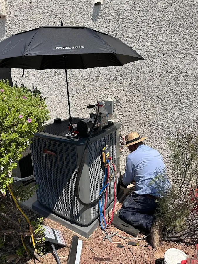 HVAC technician performing outdoor AC maintenance in Green Hill